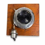 Camera Wollensak Apochromatic Raptar 1/4" 210MM F10 On Wood Board B108. Fixed Price $120.00.