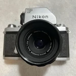 Nikon Silver Slr Film Camera W/ Nikkor Auto 55MM F/3.5 Lens. Fixed Price $120.00.