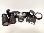 Nikon Film Camera Fe With Lens, Two Tokina Telephoto Lenses, And Other Items.. Fixed Price $336.61.